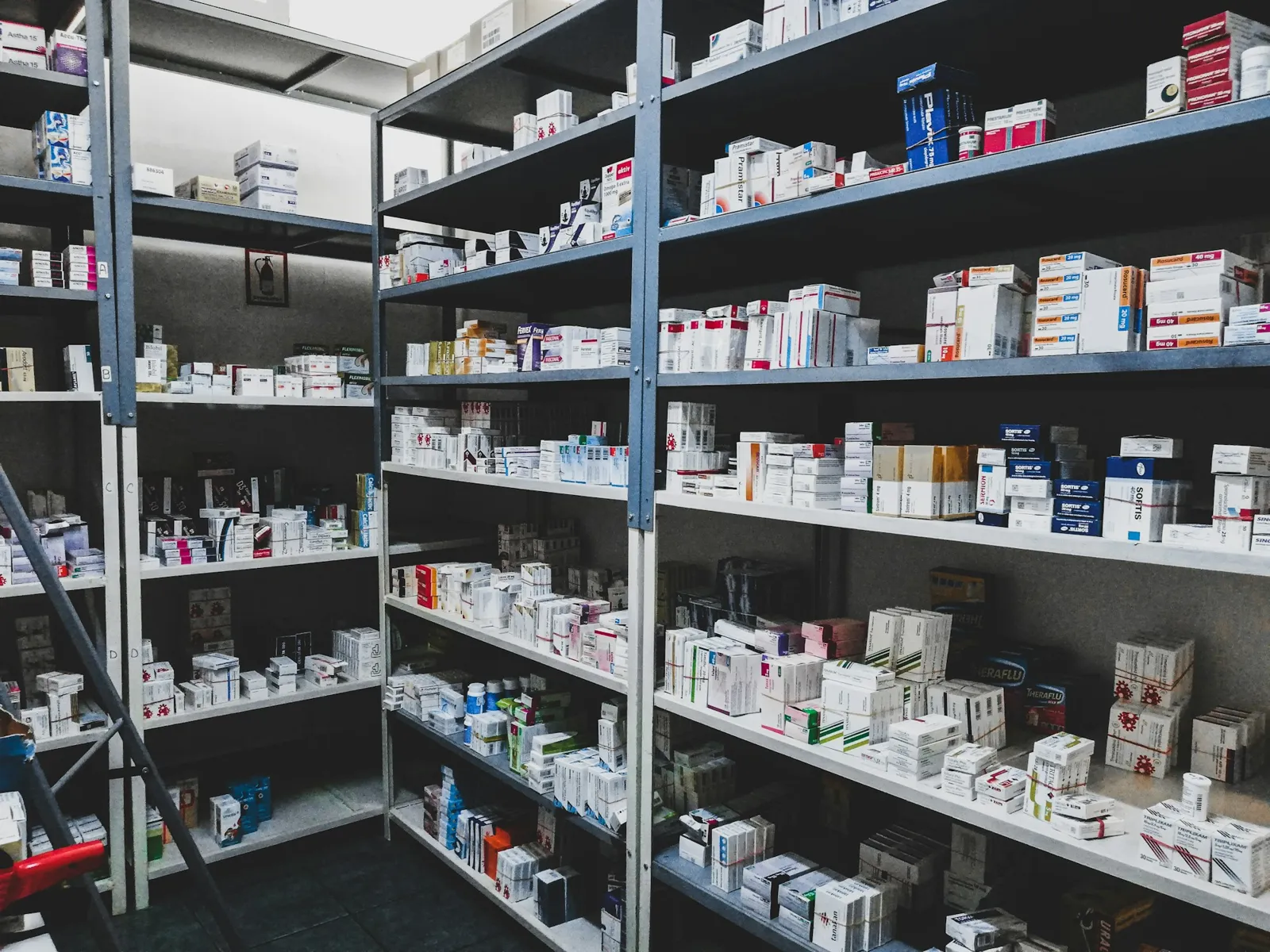 Pharmacy shelves stocked with medicine packs
