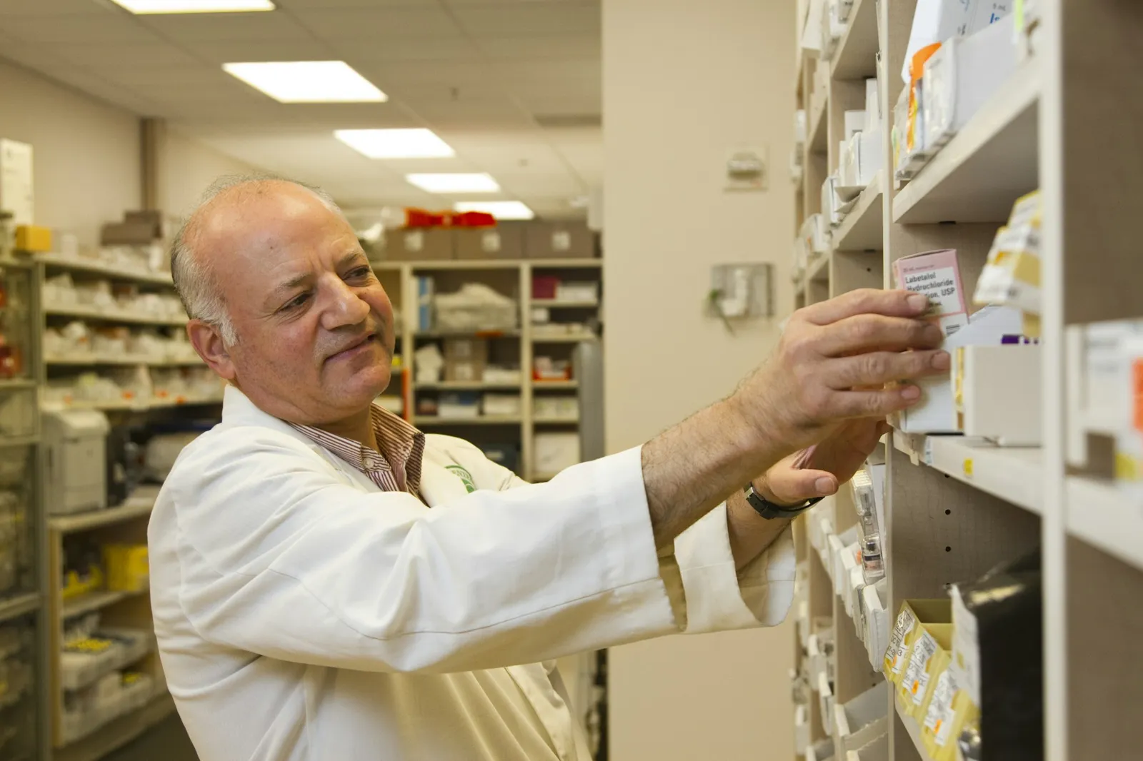 Pharmacist checking medicine stock